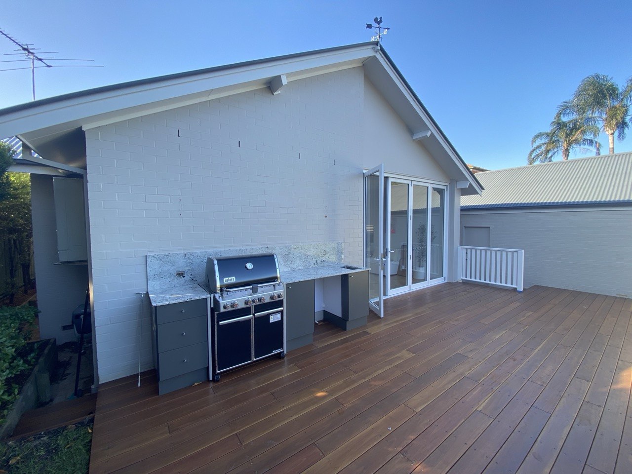 Hardwood deck with built-in outdoor kitchen and stone benchtop